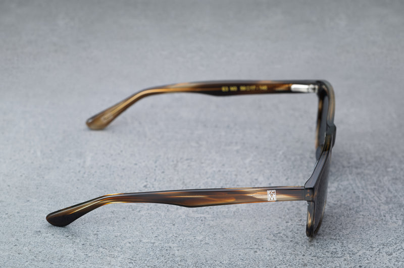dark brown glasses with dark gray lenses, open, facing right showing the frames.