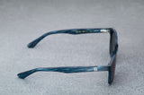 dark blue sunglasses with reflective green lenses, open, facing right showing the frames.